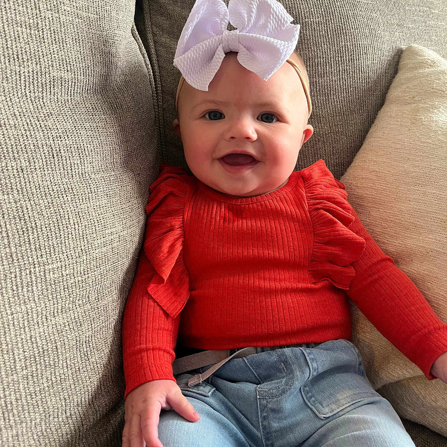 Wrenley Abigail joined the competition — help win amazing prizes! accessories, baby, clothing, couch, cushion, face, furniture, happy, hat, head, homedecor, jeans, knitwear, pants, person, photography, portrait, sitting, smile, sweater