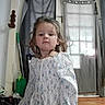 child, girl, toddler, portrait, standing, floral_dress, dress, long_hair, brown_hair, face, serious, indoors, home, window, curtains, wood_floor, mop, bucket, furniture, photography