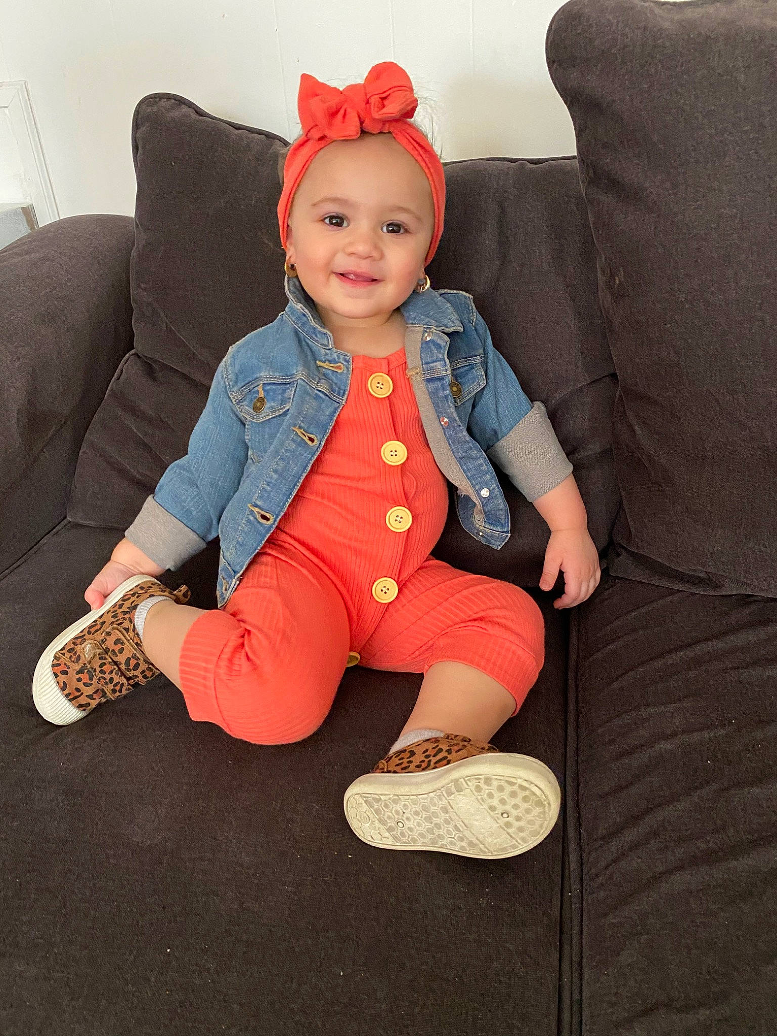 Mckenzie is registered to the contest to win money with this photo: baby, cheek, child, child_model, footwear, furniture, head, jeans, joint, joy, leg, person, shoe, sitting, skin, sleeve, toddler, toy