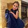 Jade a rejoint le concours — aidez-le/la à gagner de superbes lots ! child, girl, dress, blue_dress, sparkly, fireplace, stone, indoor, smile, posing, long_hair, earrings, seated, cozy, home, portrait, elegant, fancy, cute, young