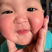 Lebron is registered to the contest to win money with this photo: child, toddler, baby, face, cheeks, drool, hand, pink_nails, eyes, close_up, rosy_cheeks, smile, skin, portrait, indoor, teal_shirt, fingertip, expression, person, young_child