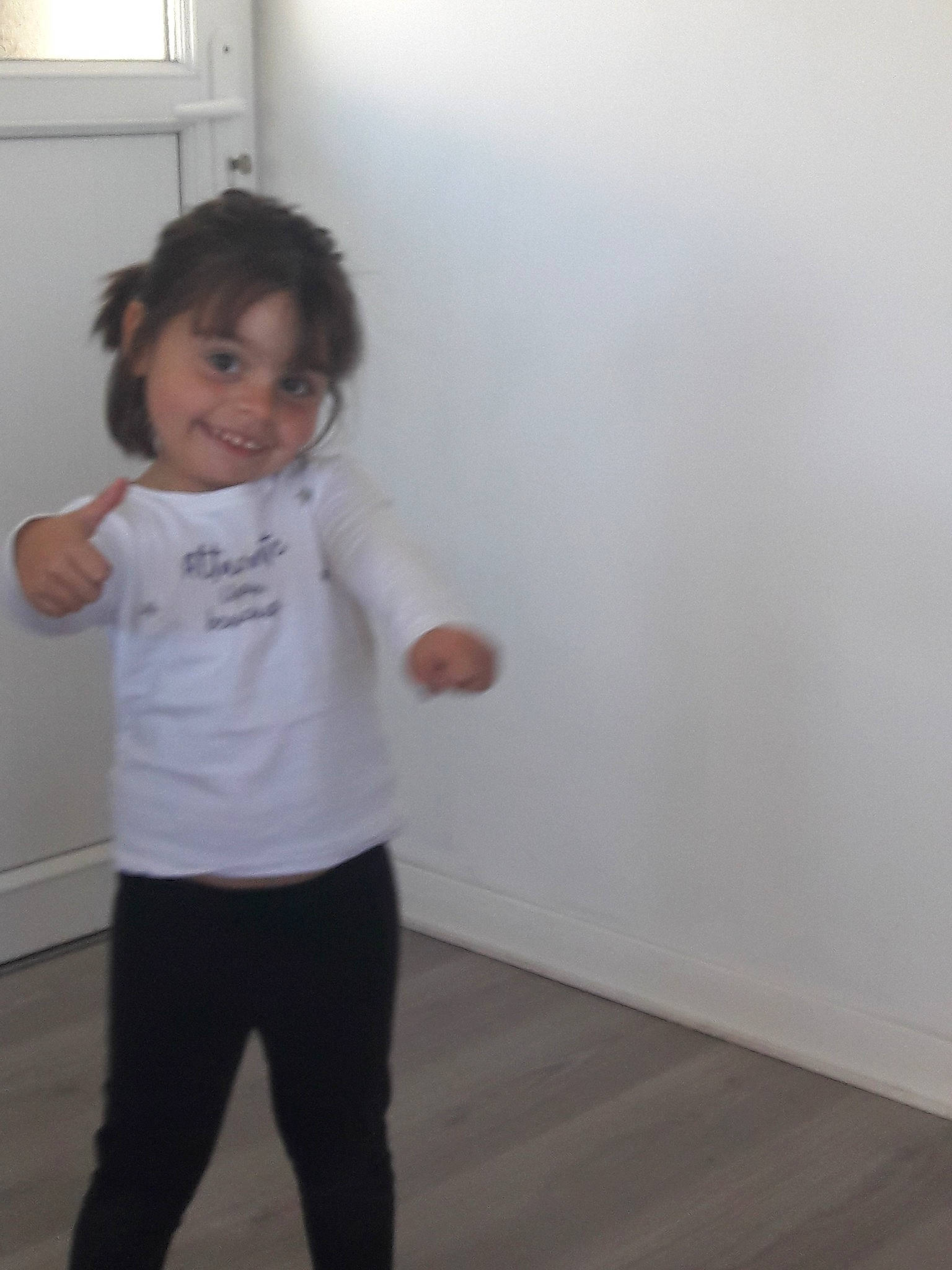 Carlota participe au concours pour gagner de l'argent avec cette photo : arm, child, clothing, day, floor, flooring, fun, girl, hip, human_body, joint, joy, leg, outerwear, person, product, shoulder, standing, t_shirt, toddler