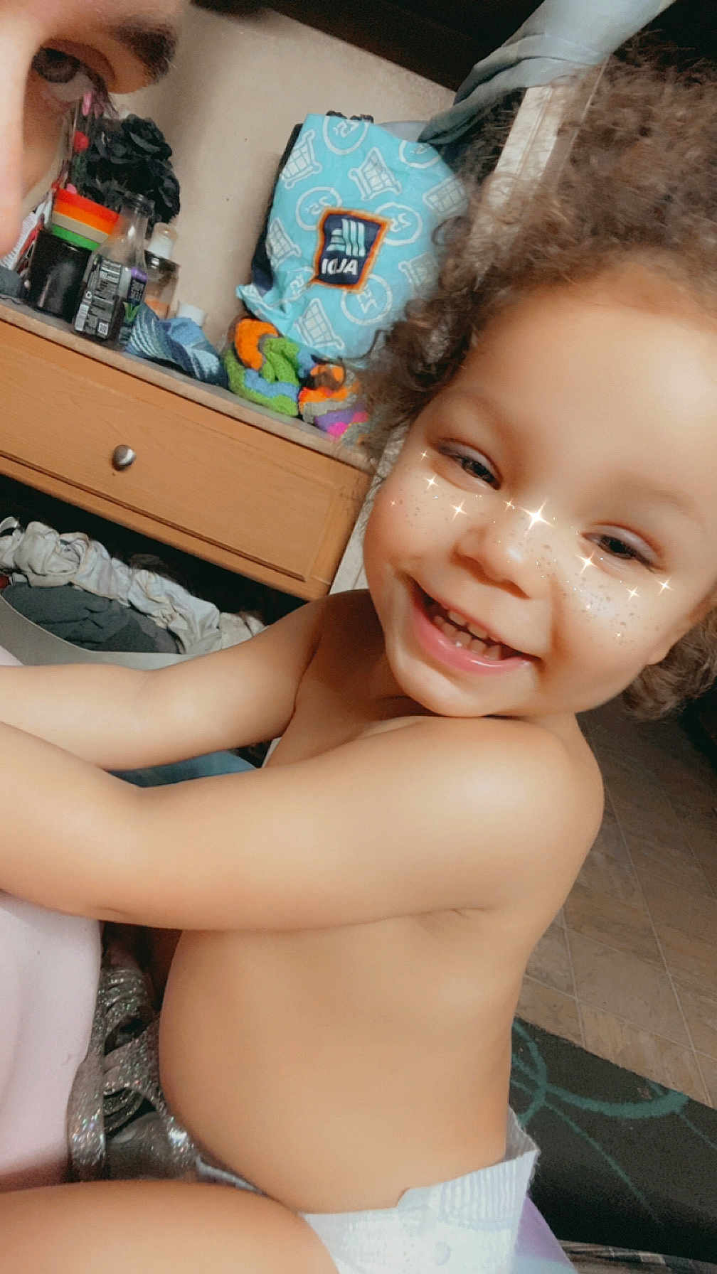 Legacy is registered to the contest to win money with this photo: toddler, child, smiling, curly_hair, indoor, diaper, face, freckles, sparkles, person, happy, cabinet, towel, clothing, floor, drawer, furniture, skin, baby, expression