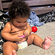 Akarii joined the competition — help win amazing prizes! baby, bed, blanket, casual, child, curly_hair, cute, diaper, focus, foot, hand, home, indoor, infant, person, playing, red_ball, skin, toy, wooden_headboard