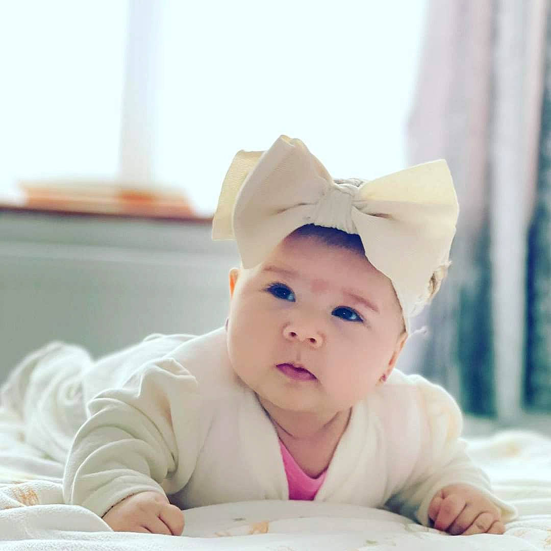 Antonia is registered to the contest to win money with this photo: baby, baby_products, baby_toddler_clothing, cheek, child, comfort, drinkware, fashion_accessory, flooring, fun, happy, headwear, person, portrait_photography, recreation, room, sitting, sleeve, smile, sweetness
