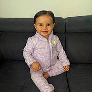 Alya a rejoint le concours — aidez-le/la à gagner de superbes lots ! toddler, child, smiling, sitting, couch, clothing, nike, purple, tracksuit, indoor, face, person, happy, hair, foot, hand, fabric, wall, home, portrait