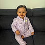 toddler, child, smiling, sitting, couch, clothing, nike, purple, tracksuit, indoor, face, person, happy, hair, foot, hand, fabric, wall, home, portrait