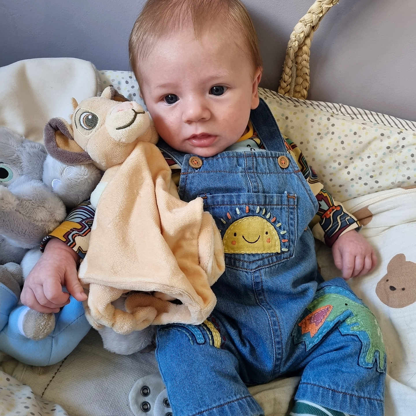 Oliver is registered to the contest to win money with this photo: americanfootball, americanfootballball, baby, ball, bed, clothing, couch, face, football, furniture, head, hosiery, jeans, pants, person, photography, portrait, sock, sport, toy