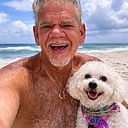 Maxi Boy joined the competition — help win amazing prizes! man, smiling_man, beach, ocean, sky, clouds, dog, white_dog, poodle, portrait, close_up, vacation, sand, waves, happy, pet, owner, gold_necklace, shirtless, beard