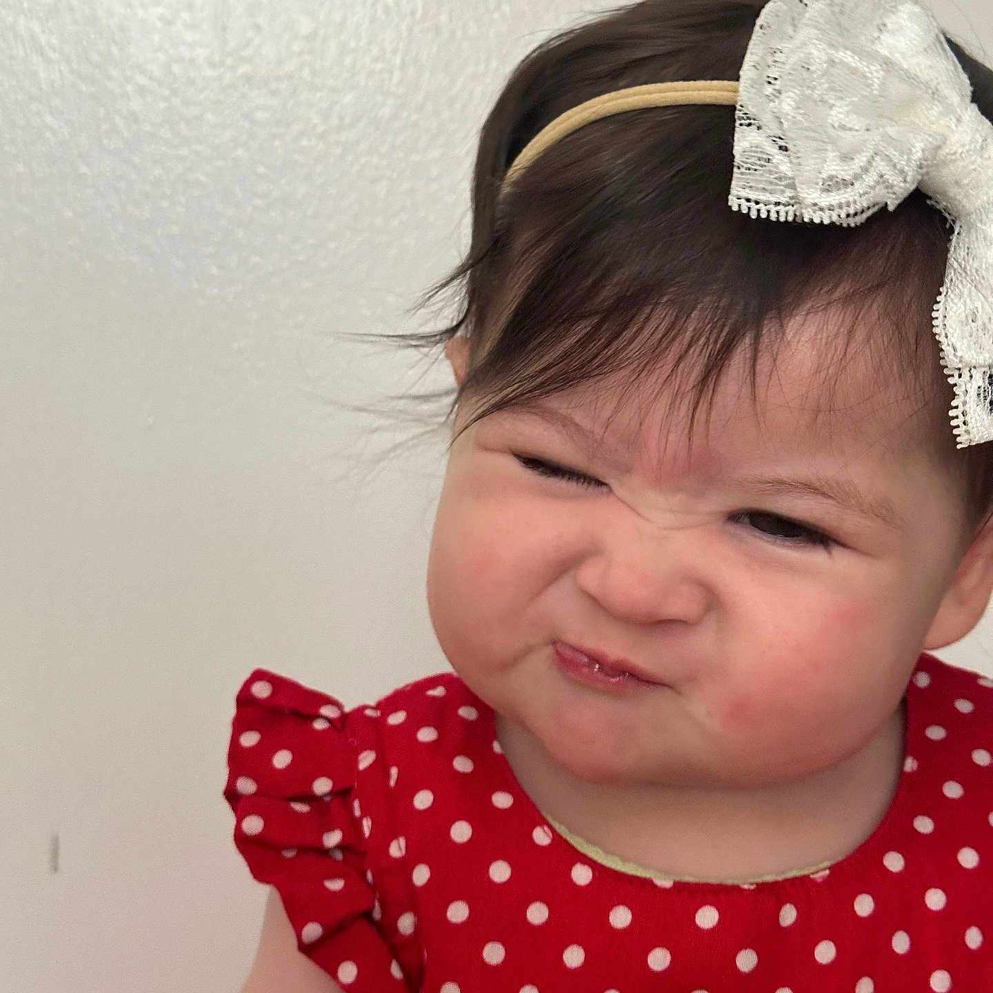Janna is registered to the contest to win money with this photo: baby, bow, child, childhood, closeup, cute, expression, face, funny_face, hair, headband, indoor, person, polka_dot, portrait, red_dress, skin, smile, toddler, young