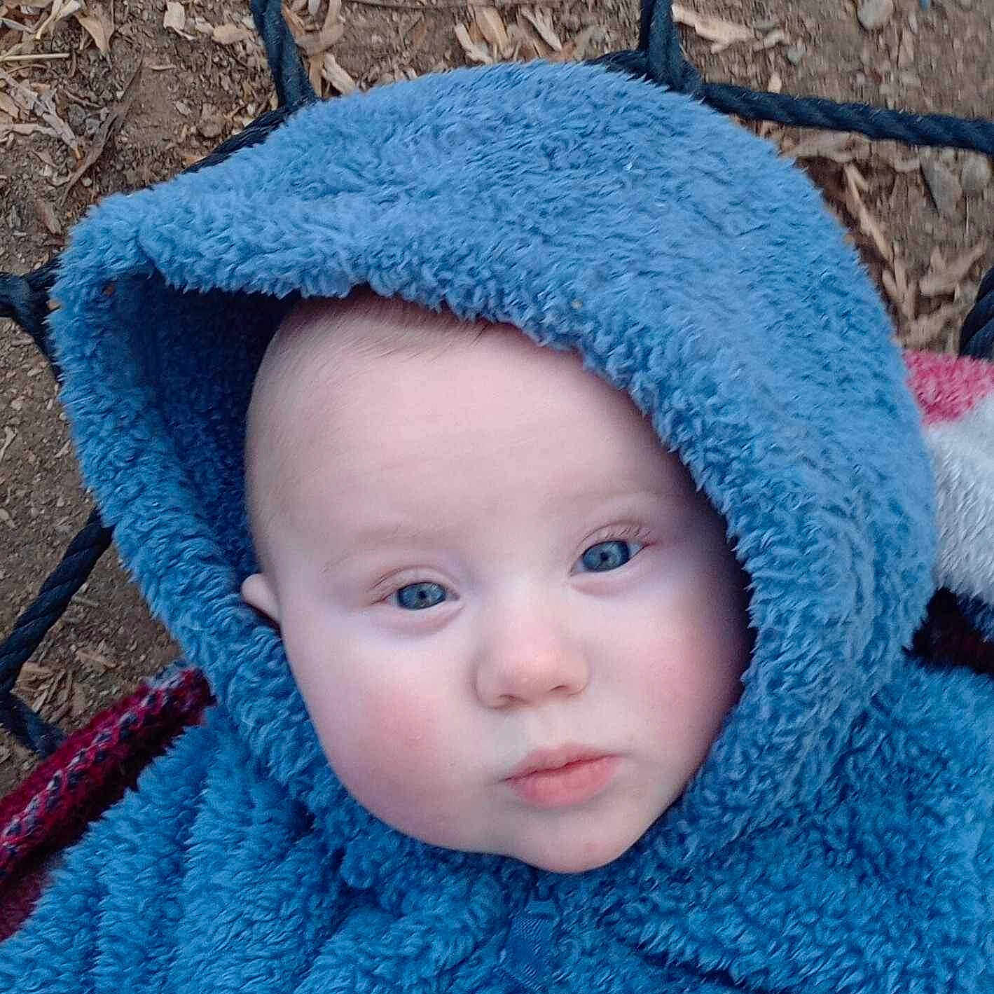 Daylin is registered to the contest to win money with this photo: baby, blanket, bonnet, cap, clothing, coat, face, hat, head, hood, hoodie, jacket, knitwear, person, photography, portrait, quilt, sweater, sweatshirt, towel