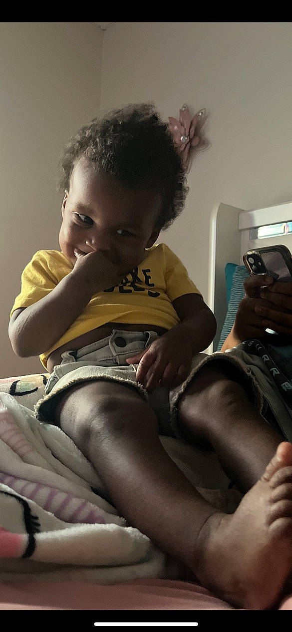 Prince is registered to the contest to win money with this photo: abdomen, baby, chest, child, comfort, elbow, eyewear, foot, hand, human_leg, joint, knee, lap, leg, person, shoulder, skin, thigh, toddler, trunk