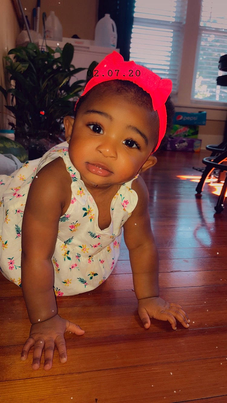 Alayah is registered to the contest to win money with this photo: baby, baby_toddler_clothing, cheek, child, floor, hair_accessory, headgear, person, skin, smile, toddler