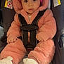 baby, infant, car_seat, pink_onesie, hat, boots, child, cute, fluffy_clothing, safety_harness, indoor, portrait, young_child, wide_eyes, adorable, warm_clothing, seated, expression, person, winter_wear