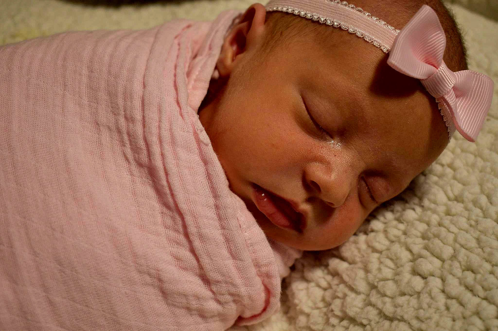 Lilly-ann is registered to the contest to win money with this photo: baby, bedtime, cheek, child, comfort, event, flesh, hair_accessory, headgear, linens, nap, person, pink, portrait_photography, room, sleep, sleeve, smile, toddler, wood