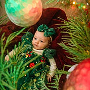 Aurora joined the competition — help win amazing prizes! baby, child, christmas, holiday, green_dress, bow, ornament, christmas_tree, decoration, red_blanket, festive, holiday_season, infant, portrait, cute, celebration, indoor, seasonal, smiling, soft_lighting