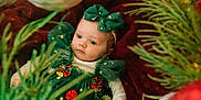 Aurora joined the competition — help win amazing prizes! baby, child, christmas, holiday, green_dress, bow, ornament, christmas_tree, decoration, red_blanket, festive, holiday_season, infant, portrait, cute, celebration, indoor, seasonal, smiling, soft_lighting