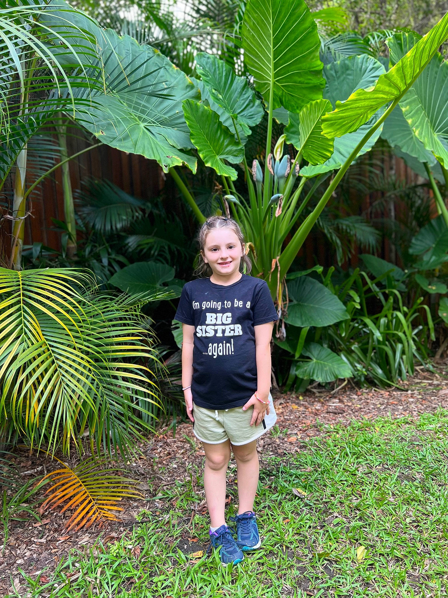 Alexis is registered to the contest to win money with this photo: arecales, banana_family, botany, flowering_plant, garden, gardening, grass, grass_family, groundcover, joy, jungle, landscaping, leaf, leisure, people_in_nature, person, plant, shorts, shrub, smile