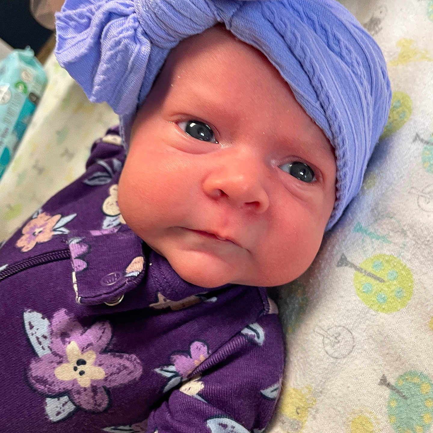 Braylin is registered to the contest to win money with this photo: baby, bed, blanket, bonnet, cap, clothing, dress, face, furniture, glove, hat, head, newborn, person, photography, portrait, purple, quilt, towel, turban