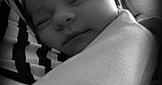 Melliana joined the competition — help win amazing prizes! baby, sleeping, black_and_white, portrait, close_up, infant, peaceful, soft_light, striped_clothing, arm, face, cozy, newborn, person, candid, monochrome, resting, cute, tender, calm