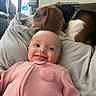 baby, beagle, blanket, cat, couch, cozy, dog, face, home_interior, indoor, infant, onesie, pet, pillow, pink_clothing, portrait, remote_control, smiling, water_bottle, window