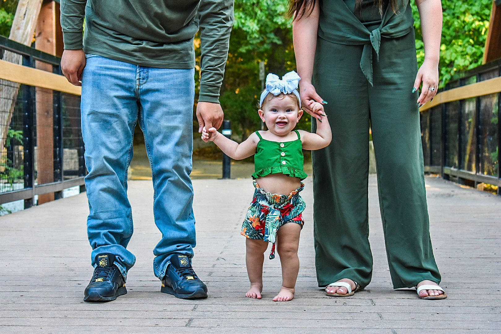 Viktoria is registered to the contest to win money with this photo: child, family, footwear, fun, gesture, green, hand, happy, holding_hands, jeans, joy, leg, people, person, photograph, photography, smile, snapshot, standing, toddler