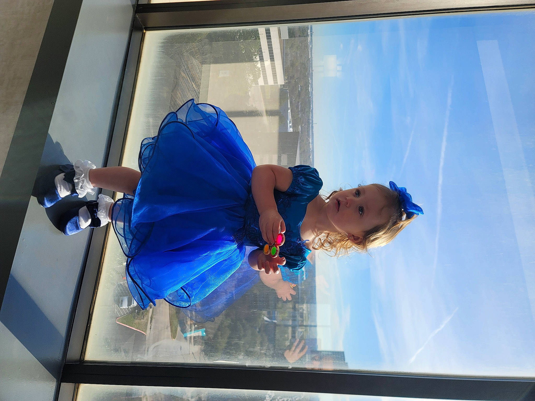 Elizabeth is registered to the contest to win money with this photo: display_device, elbow, electric_blue, event, fun, glass, leisure, person, reflection, transparent_material, water, window