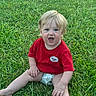 toddler, child, baby, portrait, outdoor, grass, lawn, sitting, red_shirt, blond_hair, blue_eyes, open_mouth, surprised, facial_expression, barefoot, summer, daylight, greenery, close_up, photography