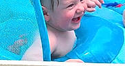 Cashton is registered to the contest to win money with this photo: child, toddler, baby, swimming, pool, water, laughing, smiling, face, portrait, outdoor, summer, wet_hair, pool_float, mesh, blue, recreation, playful, daylight, happy