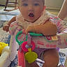Blakeleigh joined the competition — help win amazing prizes! baby, child, infant, portrait, sitting, surprised, open_mouth, blue_eyes, activity_center, baby_toy, colorful, indoor, home, rocking_chair, window, sunlight, rug, playtime, clothing, happy
