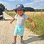 toddler, child, smiling, nike_cap, shorts, sandals, outdoor, sunny, gravel_path, grass, stroller, blue_sky, clouds, summer, happy, walking, nature, field, casual_clothing, daytime