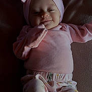 Jazmyn joined the competition — help win amazing prizes! baby, infant, smile, pink_clothing, headband, bow, floral_pants, lying_down, blanket, soft_lighting, cute, child, face, portrait, indoors, comfort, happy, young, apparel, person