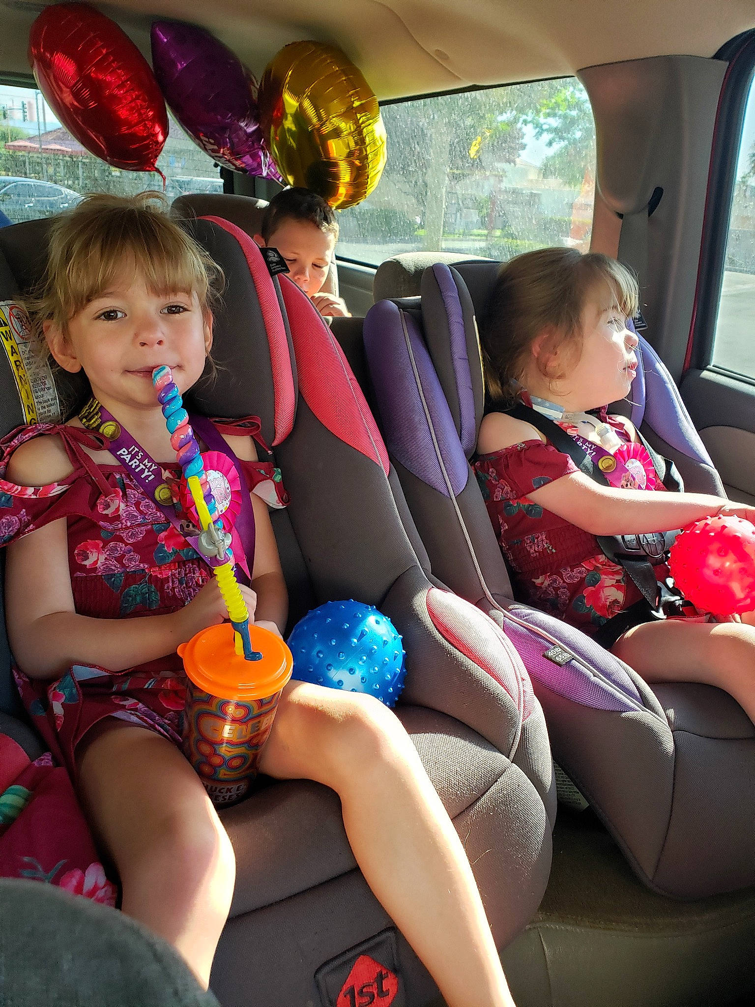 Odessa is registered to the contest to win money with this photo: auto_part, balloon, car, car_seat, child, family_car, fun, party, party_supply, person, sitting, toddler, vacation, vehicle