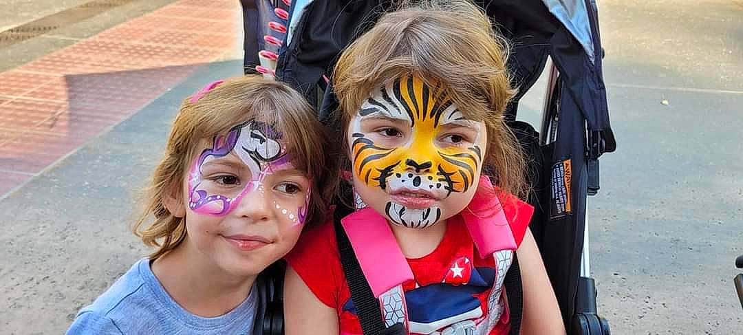 Sunny Mae is registered to the contest to win money with this photo: child, clown, costume, entertainment, event, eyelash, eyewear, fan, fun, happy, leisure, masque, mouth, nose, people, performing_arts, person, personal_protective_equipment, smile, t_shirt