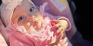 Scarlett joined the competition — help win amazing prizes! baby, child, infant, car_seat, pink_clothing, headband, flower_headband, hands, sunlight, portrait, cute, soft_fabric, floral_pattern, close_up, indoor, seatbelt, face, person, young_child, comfort