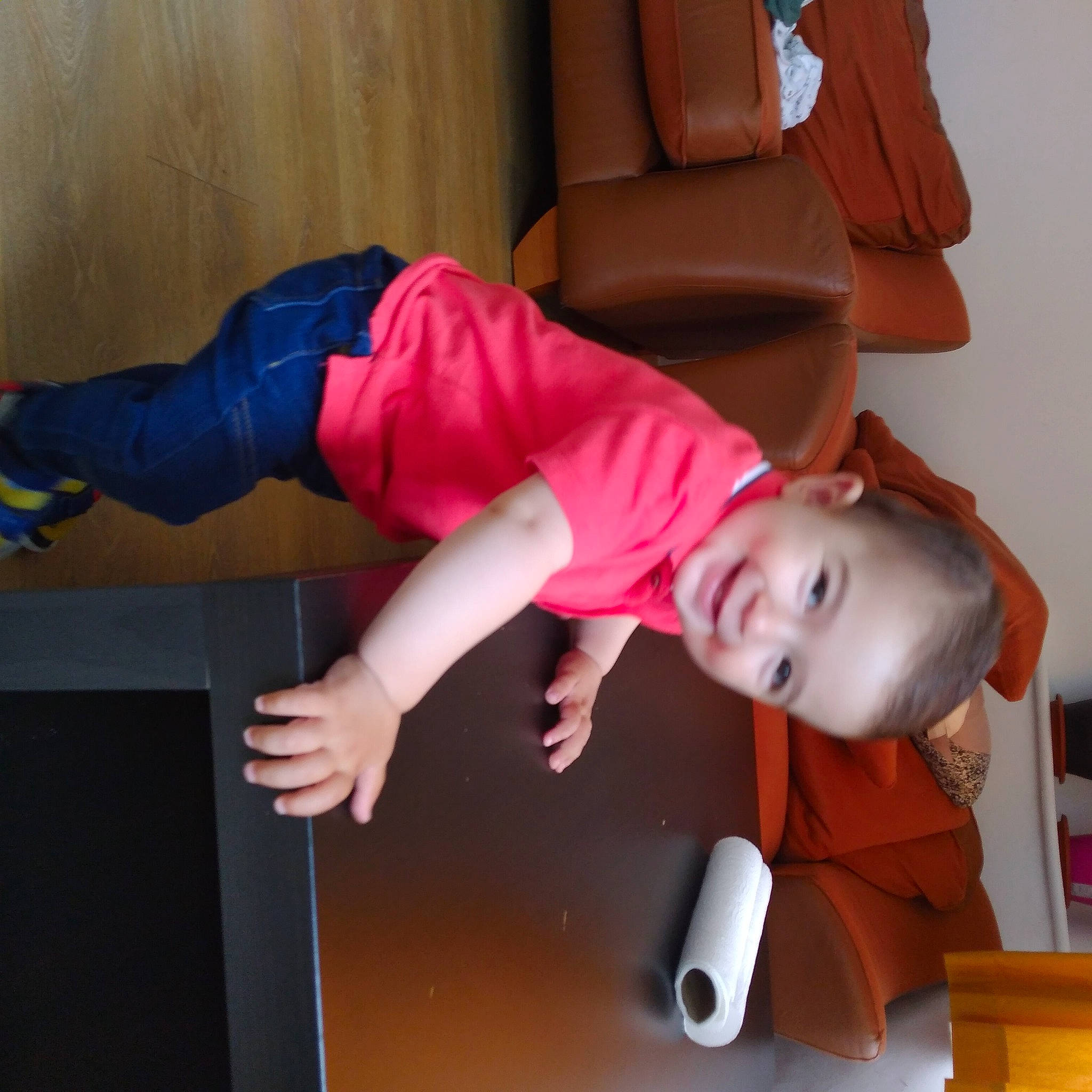 Ajan is registered to the contest to win money with this photo: audio_equipment, baby, child, comfort, elbow, flooring, fun, gadget, human_leg, joy, knee, person, play, room, sitting, sleeve, smile, sportswear, t_shirt, toddler