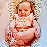Penelope is registered to the contest to win money with this photo: baby, infant, smile, face, hands, feet, bib, clothing, patterned, seat, cute, child, skin, arm, legs, cozy, indoors, portrait, happy, young