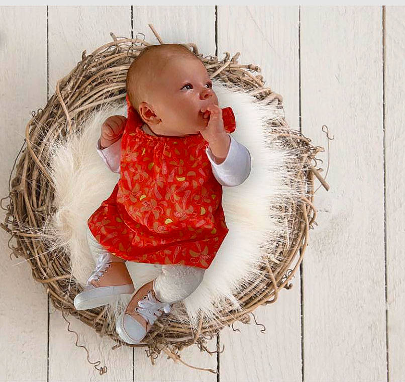 Shanna participe au concours pour gagner de l'argent avec cette photo : baby, baby_products, baby_toddler_clothing, baby_toys, basket, child, doll, fashion_accessory, fur, headgear, ornament, pattern, person, room, sitting, sleeve, stuffed_toy, textile, toddler, toy