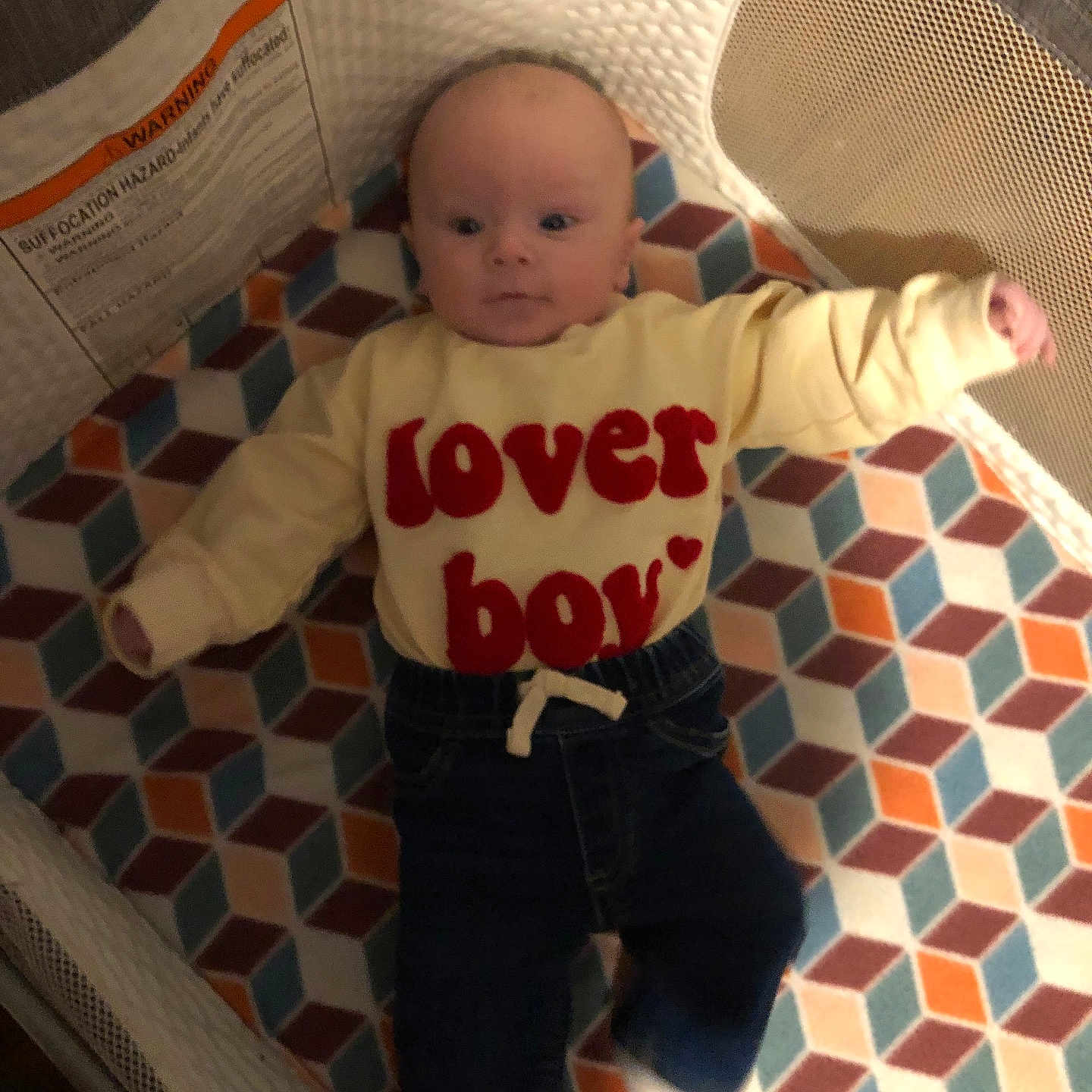 Elijah joined the competition — help win amazing prizes! baby, bed, clothing, couch, cradle, crib, cushion, face, furniture, head, homedecor, infantbed, jeans, newborn, pants, person, photography, portrait, quilt, standing