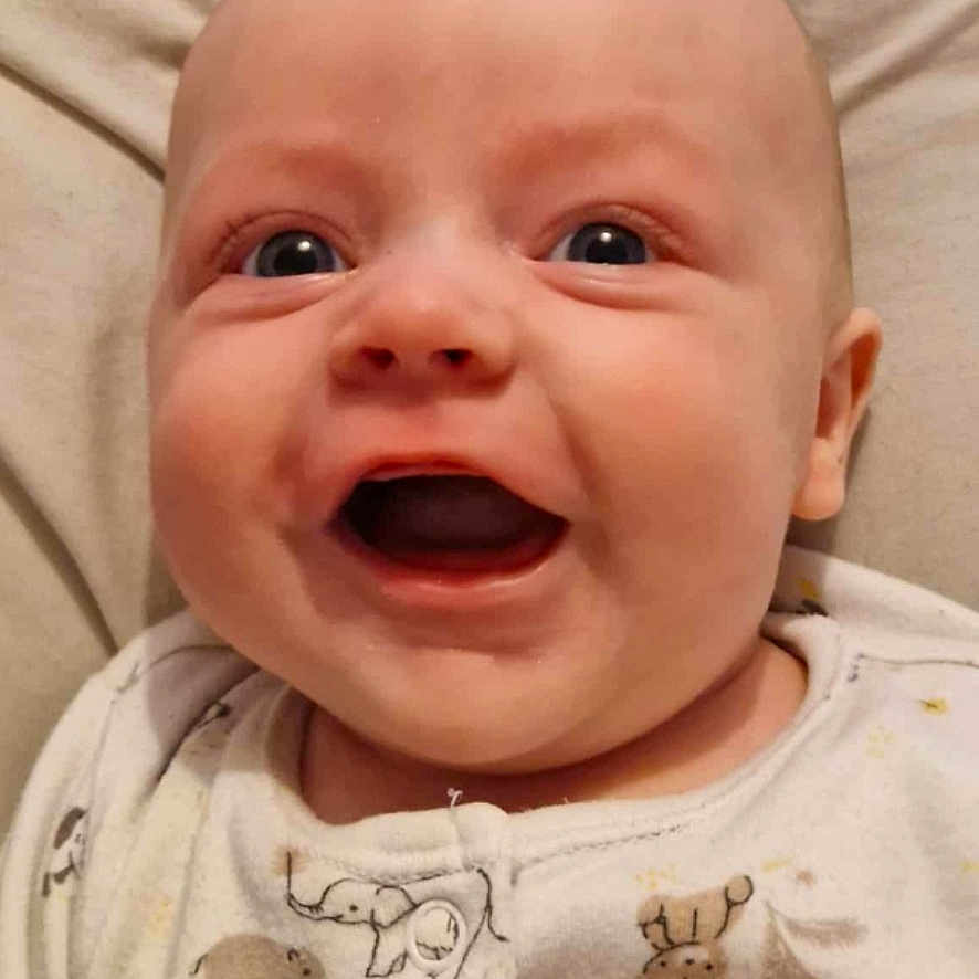 Arley-Bowe joined the competition — help win amazing prizes! animal_print, baby, bedtime, blue_eyes, child, clothing, cushion, cute, face, hand, happy, indoors, infant, lying_down, onesie, portrait, skin, smiling, soft_fabric, young_child