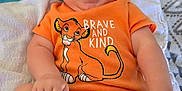 Karson is registered to the contest to win money with this photo: baby, blanket, brave_and_kind, child, chubby_cheeks, cute, disney, happy, indoors, infant, lying_down, orange_onesie, patterned_blanket, person, playful, simba, smiling, toddler, tongue_out, young_child