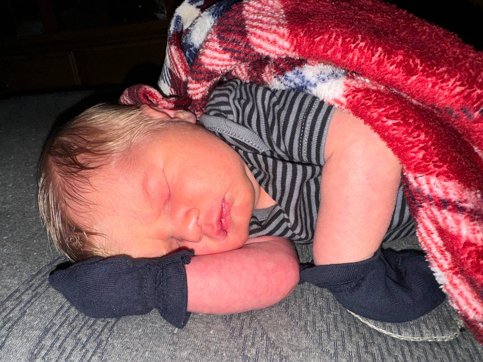 Declan is registered to the contest to win money with this photo: abdomen, baby, bedtime, child, comfort, fashion_accessory, flash_photography, flesh, flooring, fun, human_leg, linens, magenta, nail, nap, pattern, person, sitting, sleep, thigh