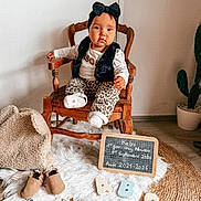 Kelya participe au concours pour gagner de l'argent avec cette photo : toddler, child, chair, headband, bow, leopard_print, pants, socks, wooden_chair, chalkboard, alphabet_blocks, abc, rug, blanket, baby_shoes, cactus, indoor, floor, cute, portrait