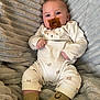Carter is registered to the contest to win money with this photo: baby, pacifier, blanket, soft_texture, bear_pattern, socks, smile, infant, clothing, cute, child, face, person, indoors, comfort, resting, seated, warm, casual, cozy
