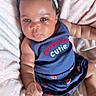 Nova is registered to the contest to win money with this photo: baby, infant, child, face, headband, bow, blanket, pink, navy_blue, clothing, sitting, cute, adorable, skin, hand, foot, expression, portrait, indoor, soft