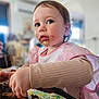 toddler, child, cake, chocolate, food, messy, bib, pink, gingham, table, hand, face, indoor, blurred_background, cute, eating, young_child, portrait, person, cozy