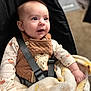 apparel, baby, baby_bib, baby_clothes, blanket, car_seat, car_seat_harness, child, clothing, cute, face, happy, indoors, infant, person, seatbelt, sitting, smile, soft_texture, winnie_the_pooh
