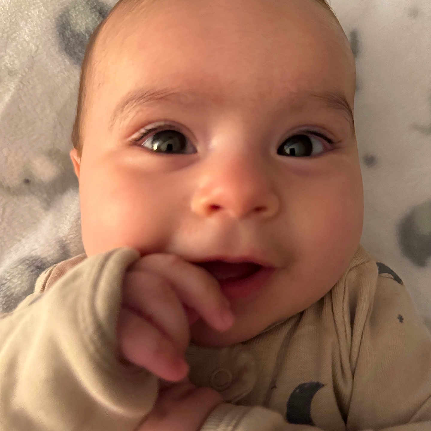 Jr. joined the competition — help win amazing prizes! baby, beige, blanket, child, close_up, cozy, cute, expression, eyes, face, hand, indoors, infant, lying_down, pajamas, portrait, skin, smile, soft, young