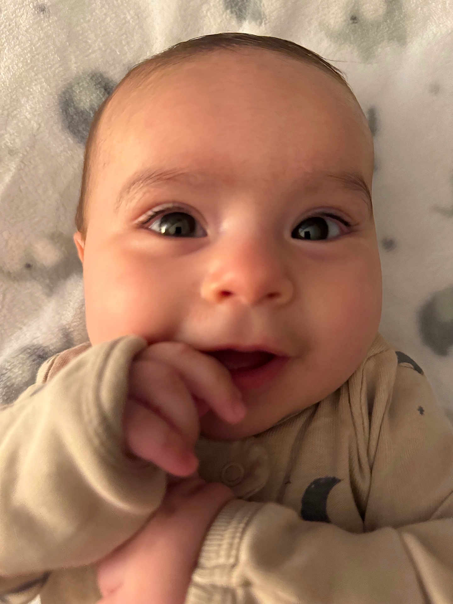 Jr. joined the competition — help win amazing prizes! baby, infant, close_up, face, eyes, hand, pajamas, beige, blanket, soft, cute, smile, child, young, skin, portrait, indoors, expression, lying_down, cozy