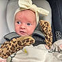 Jasmine joined the competition — help win amazing prizes! baby, infant, car_seat, blanket, mittens, headband, bow, clothing, face, person, child, seated, indoor, soft_texture, patterned_clothing, animal_print, cute, young_child, comfort, portrait